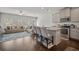 Modern kitchen with stainless appliances, granite counters, and island seating, adjacent to a comfortable living area at 7083 Gladstone Cir, Stonecrest, GA 30038