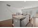 Open kitchen with granite countertops and stainless steel appliances flowing into the living area at 7083 Gladstone Cir, Stonecrest, GA 30038