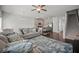 Open-concept living area featuring a comfortable sofa, kitchen island, and modern decor at 7083 Gladstone Cir, Stonecrest, GA 30038