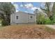 Home featuring neutral siding, green landscaping, and a partially visible driveway at 1679 Sw Lisbon Sw Dr, Atlanta, GA 30310