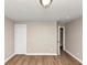 View of this empty bedroom features wood-look flooring and a walk-in closet at 1679 Sw Lisbon Sw Dr, Atlanta, GA 30310