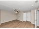 A spacious bedroom featuring wood-look floors, ceiling fan, and a closet at 1679 Sw Lisbon Sw Dr, Atlanta, GA 30310