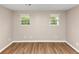 A bedroom featuring laminate flooring and natural light from the two windows at 1679 Sw Lisbon Sw Dr, Atlanta, GA 30310