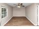 An empty bedroom featuring wood-look floors and a ceiling fan with a light at 1679 Sw Lisbon Sw Dr, Atlanta, GA 30310