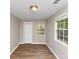 Neutral bedroom with laminate flooring, natural light, and spacious closet at 1679 Sw Lisbon Sw Dr, Atlanta, GA 30310