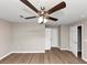 A spacious empty bedroom featuring wood-look floors, ceiling fan, and a closet at 1679 Sw Lisbon Sw Dr, Atlanta, GA 30310