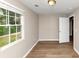 Bright bedroom features wood-look flooring, a large window, and a neutral color palette at 1679 Sw Lisbon Sw Dr, Atlanta, GA 30310