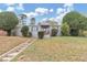 Charming one-story home featuring a well-manicured lawn, mature trees, and inviting front porch at 1679 Sw Lisbon Sw Dr, Atlanta, GA 30310
