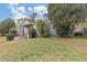 A one-story home displaying a landscaped front yard with mature trees and shrubbery at 1679 Sw Lisbon Sw Dr, Atlanta, GA 30310
