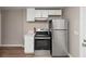 A bright kitchen with stainless steel appliances, ample countertop space, and bright white cabinets at 1679 Sw Lisbon Sw Dr, Atlanta, GA 30310