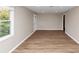 Living room boasting sleek flooring, and neutral walls, complemented by natural light from a window at 1679 Sw Lisbon Sw Dr, Atlanta, GA 30310