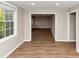 Bright living room featuring wood-look flooring, neutral walls, and large windows for lots of natural light at 1679 Sw Lisbon Sw Dr, Atlanta, GA 30310