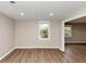 Living room boasting sleek flooring, neutral walls, complemented by natural light streaming through the windows at 1679 Sw Lisbon Sw Dr, Atlanta, GA 30310