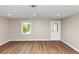 Bright living room with wood-look flooring, fresh neutral paint, and plenty of natural light at 1679 Sw Lisbon Sw Dr, Atlanta, GA 30310