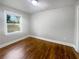 Bright, empty bedroom with a window and hardwood floors at 1886 Hazelwood Se Dr, Marietta, GA 30067