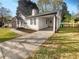 Charming single-story home featuring white siding, black shutters, a covered carport, and a long driveway at 1886 Hazelwood Se Dr, Marietta, GA 30067