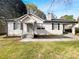 Charming single-story home featuring white siding, black shutters, covered carport, and inviting front entrance at 1886 Hazelwood Se Dr, Marietta, GA 30067