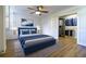 Comfortable bedroom featuring a ceiling fan, stylish decor, and an organized walk-in closet with ample storage at 2965 Pharr Court South Nw # 503, Atlanta, GA 30305