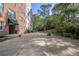 Condominium brick building with patio area, furniture and natural surroundings at 2965 Pharr Court South Nw # 503, Atlanta, GA 30305