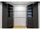 Well-organized walk-in closet boasts built-in shelving, drawers, and hanging rods for storage solutions at 2965 Pharr Court South Nw # 503, Atlanta, GA 30305