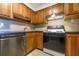 Kitchen with stainless steel appliances, wood cabinets, and black countertops at 2965 Pharr Court South Nw # 503, Atlanta, GA 30305