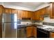 Kitchen with stainless steel appliances, wood cabinets, and tile backsplash at 2965 Pharr Court South Nw # 503, Atlanta, GA 30305