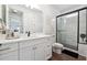 Bright bathroom with a white vanity, quartz countertop, modern fixtures, and a glass-enclosed shower at 3515 Montebello Pkwy, Cumming, GA 30028