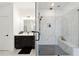 Spacious bathroom with double shower featuring glass doors, marble tiling, and dark wood vanity at 3515 Montebello Pkwy, Cumming, GA 30028