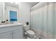 Clean bathroom featuring a white vanity, toilet, and a shower with a light blue striped shower curtain at 3515 Montebello Pkwy, Cumming, GA 30028