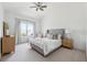 Cozy bedroom with carpeted floors, a ceiling fan, bright window, and a neutral color palette at 3515 Montebello Pkwy, Cumming, GA 30028