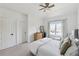 Serene bedroom featuring a ceiling fan, bright window, neutral decor, and soft carpeted flooring at 3515 Montebello Pkwy, Cumming, GA 30028