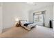 Cozy bedroom with carpet flooring and a large window with backyard view at 3515 Montebello Pkwy, Cumming, GA 30028