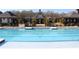 Inviting community pool with clear blue water, poolside seating, and a charming clubhouse in the background at 3515 Montebello Pkwy, Cumming, GA 30028