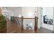 Open hallway with hardwood floors, a modern chandelier, and a view of an adjacent bedroom at 3515 Montebello Pkwy, Cumming, GA 30028
