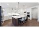 Beautiful white kitchen with an island, stainless appliances, and modern lighting at 3515 Montebello Pkwy, Cumming, GA 30028
