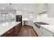 Open kitchen with white cabinets, stainless steel appliances, and large island at 3515 Montebello Pkwy, Cumming, GA 30028