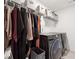 Functional laundry room featuring a washer and dryer, wire shelving, and hanging storage at 3515 Montebello Pkwy, Cumming, GA 30028