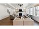 Bright living room with fireplace, built-ins, ceiling fan, hardwood floors, and large windows offering lots of natural light at 3515 Montebello Pkwy, Cumming, GA 30028