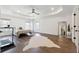 Large primary bedroom with hardwood floors, tray ceiling, and lots of natural light at 3515 Montebello Pkwy, Cumming, GA 30028