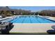 Large community pool with marked lanes, lounge chairs and tables for residents to relax poolside at 3515 Montebello Pkwy, Cumming, GA 30028