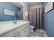 Well-lit bathroom with a shower and a modern white vanity with a light countertop at 4870 Odum View Ln, Cumming, GA 30040
