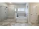 Bathroom with glass enclosed shower and separate soaking tub at 4870 Odum View Ln, Cumming, GA 30040