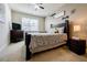 Cozy bedroom featuring a queen bed, ceiling fan, window, and a warm, inviting decor at 4870 Odum View Ln, Cumming, GA 30040
