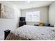 Well-lit bedroom with a large window, decorative painting, television, and comfortable furniture at 4870 Odum View Ln, Cumming, GA 30040