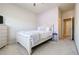 Cozy bedroom with carpet flooring, and a bed with white bedding, and a white dresser at 4870 Odum View Ln, Cumming, GA 30040