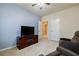 Cozy room with a TV set, ceiling fan, and two doors, perfect for entertainment at 4870 Odum View Ln, Cumming, GA 30040