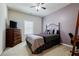 Comfortable bedroom with a bed, dresser, desk, and ample natural light for a cozy ambiance at 4870 Odum View Ln, Cumming, GA 30040
