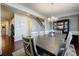 Dining room with modern chandelier, adjacent to staircase, provides a comfortable space at 4870 Odum View Ln, Cumming, GA 30040