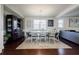 Inviting dining room with modern chandelier, wooden floors and adjacent living room at 4870 Odum View Ln, Cumming, GA 30040
