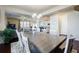 Dining area open to the living room and kitchen, features a modern chandelier and table at 4870 Odum View Ln, Cumming, GA 30040